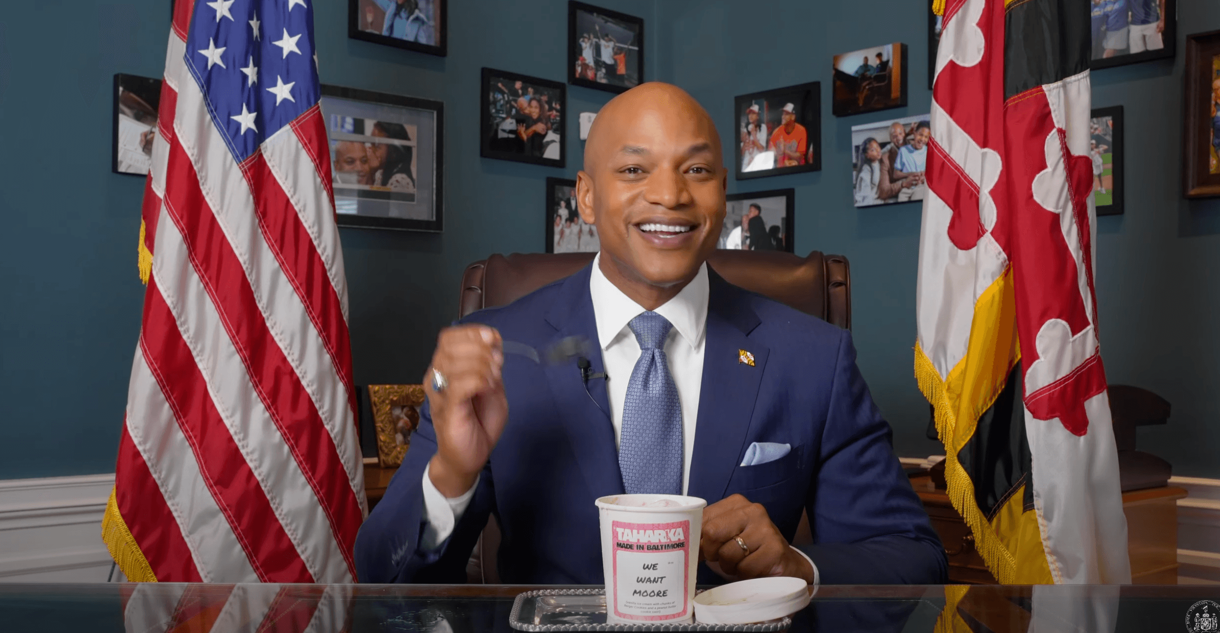 Wes Moore at his desk as Maryland governor, eating a pint of Taharka Brothers Ice Cream