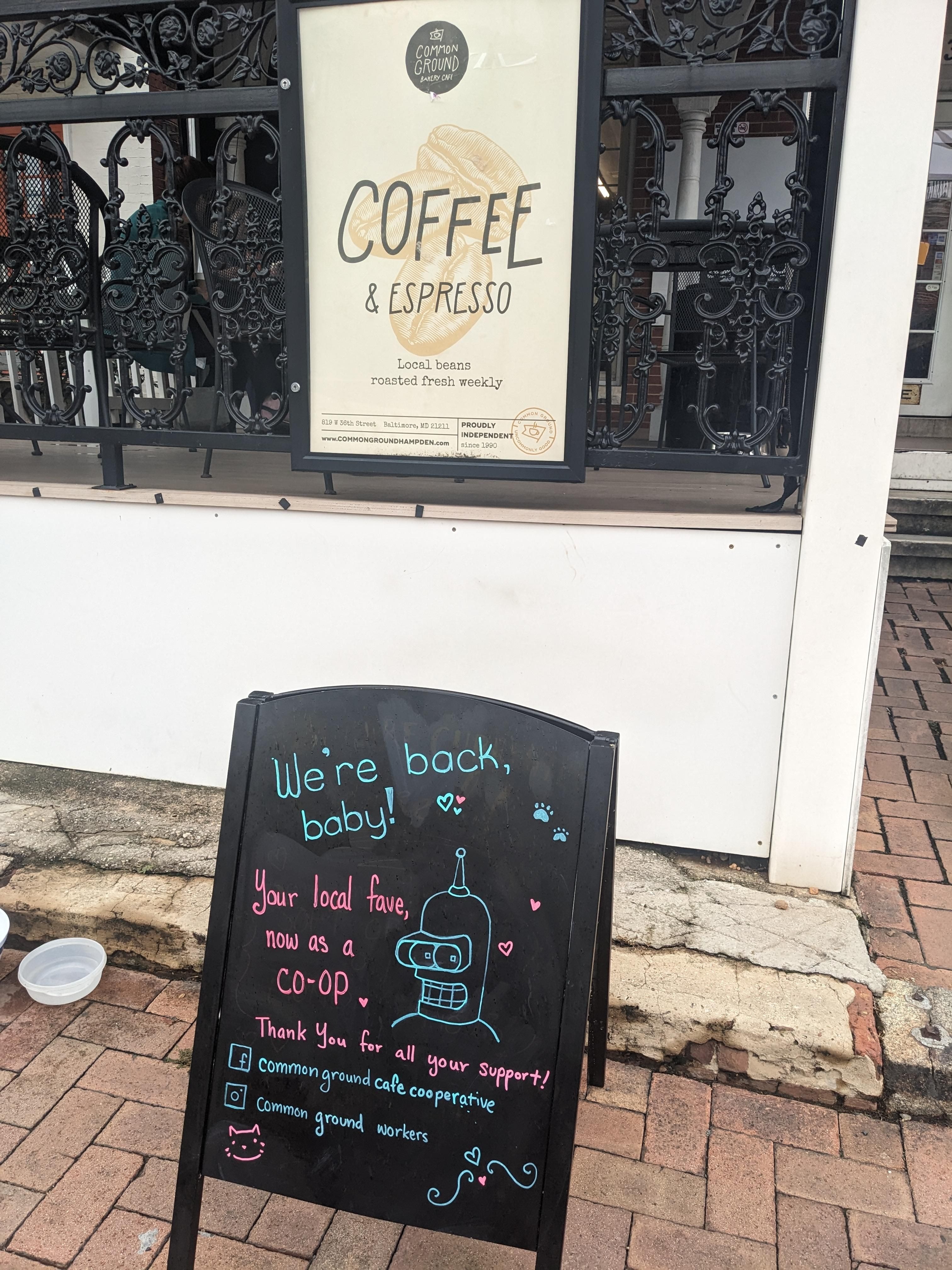 A hand-lettered sign announcing the reopening of Baltimore's Common Ground Cafe as a worker cooperative.